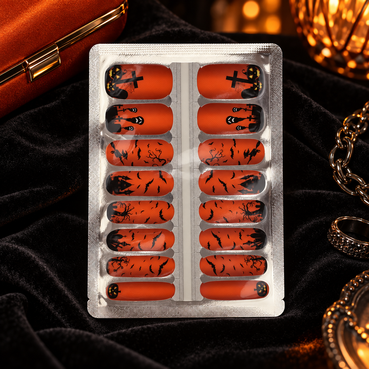 Orange Haunted Graveyard Halloween nail wraps in evening glow