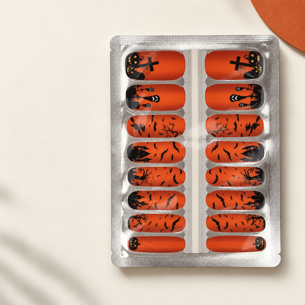 Orange Halloween nail wrap sheet with bats, witch and jack o lanterns