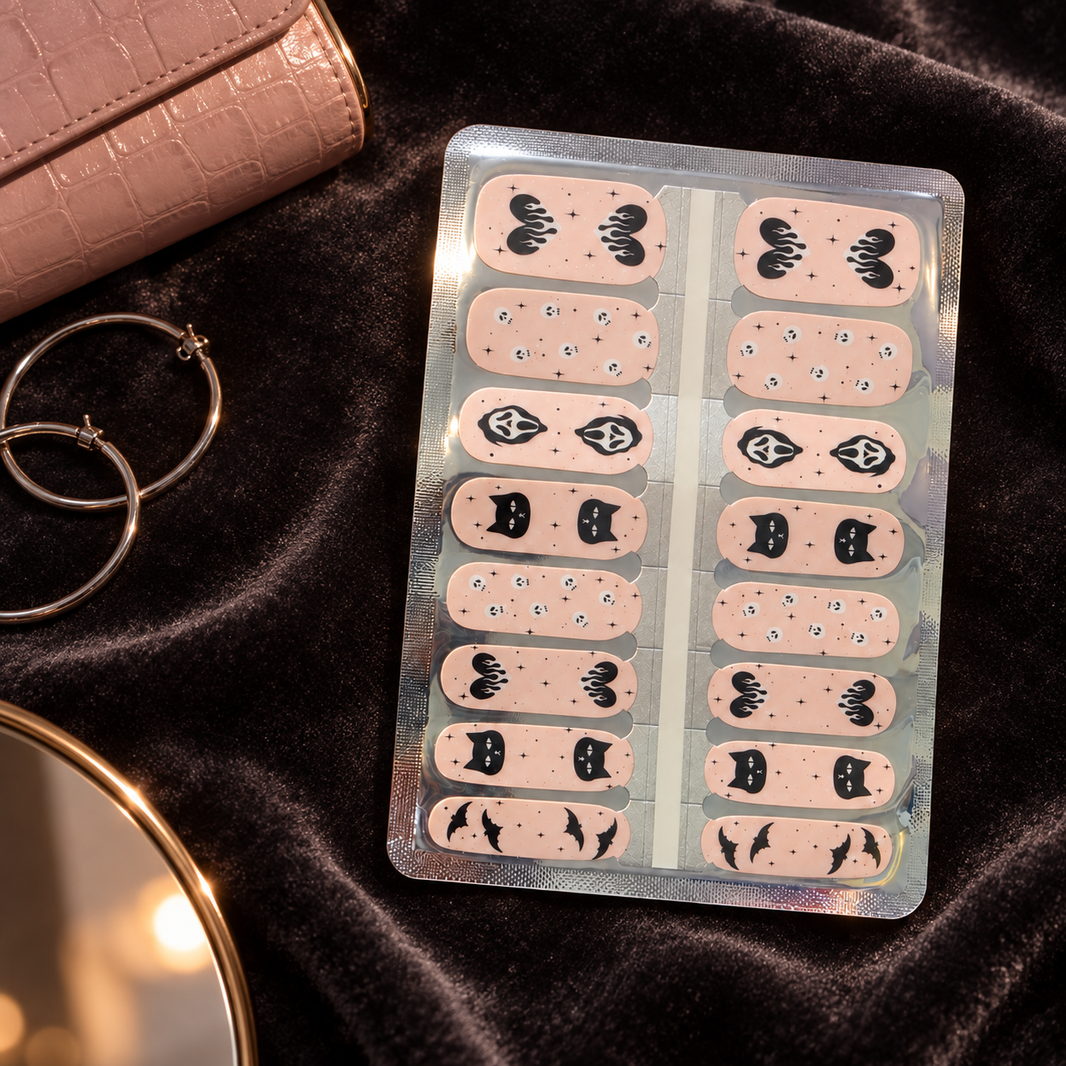 Pastel pink Halloween nail wraps with skulls, bats and star sparkles